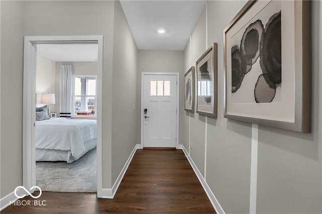 doorway to outside featuring dark wood-style floors and baseboards