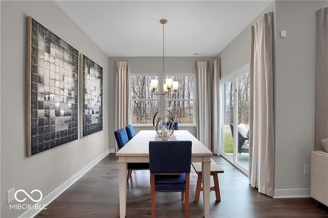 dining area with baseboards, dark wood-style flooring, and an inviting chandelier