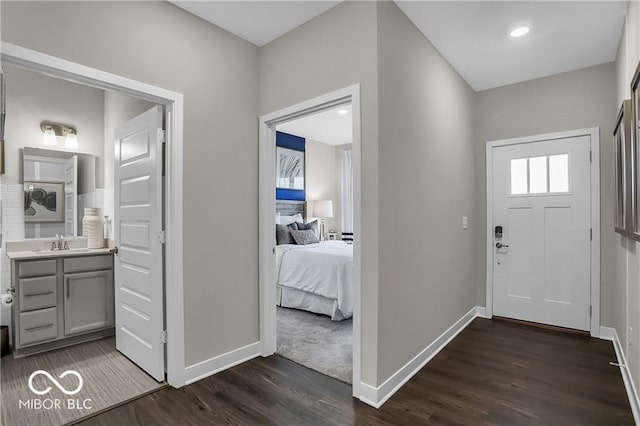 entryway featuring dark wood-style flooring and baseboards