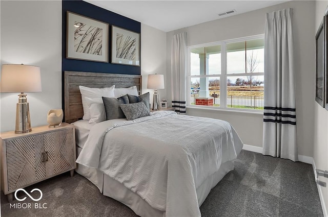 carpeted bedroom featuring baseboards and visible vents