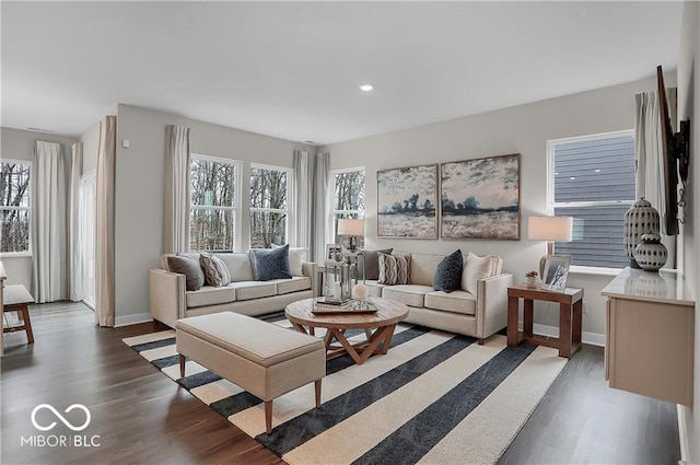 living room with recessed lighting, plenty of natural light, baseboards, and wood finished floors