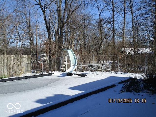 snowy yard with fence