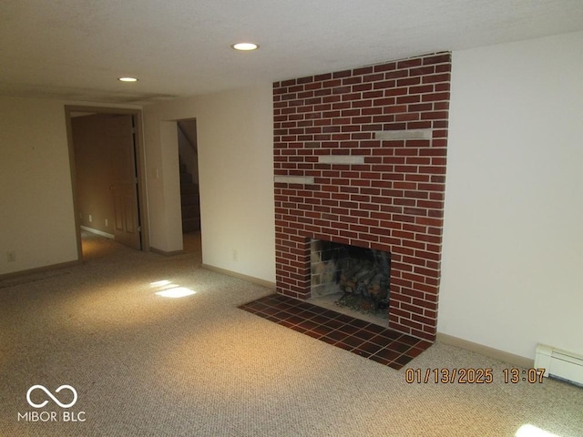 unfurnished living room featuring a baseboard radiator, carpet, a fireplace, and baseboards