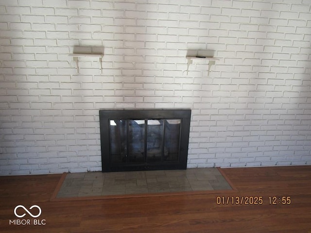 room details featuring a fireplace and wood finished floors