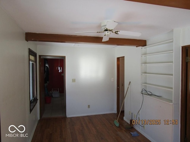 empty room featuring a ceiling fan, baseboards, and wood finished floors