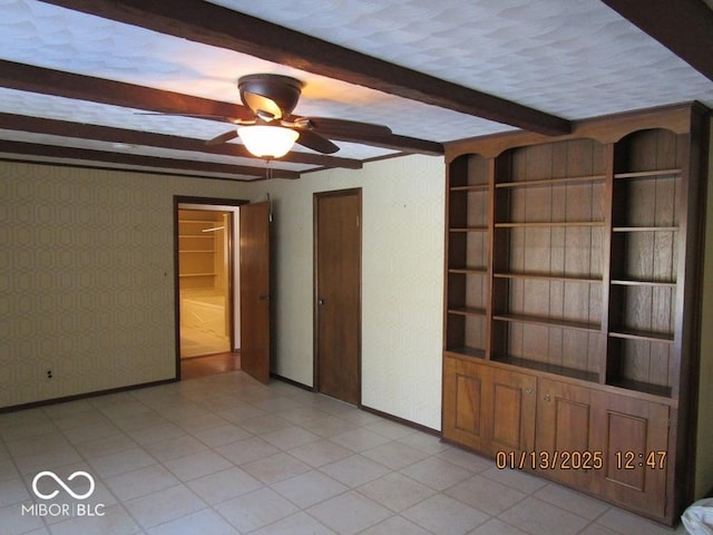 interior space with beam ceiling, baseboards, and light tile patterned floors