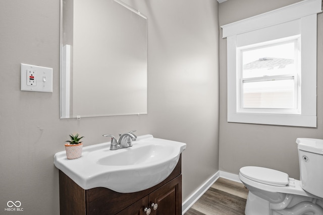 bathroom featuring hardwood / wood-style flooring, vanity, and toilet