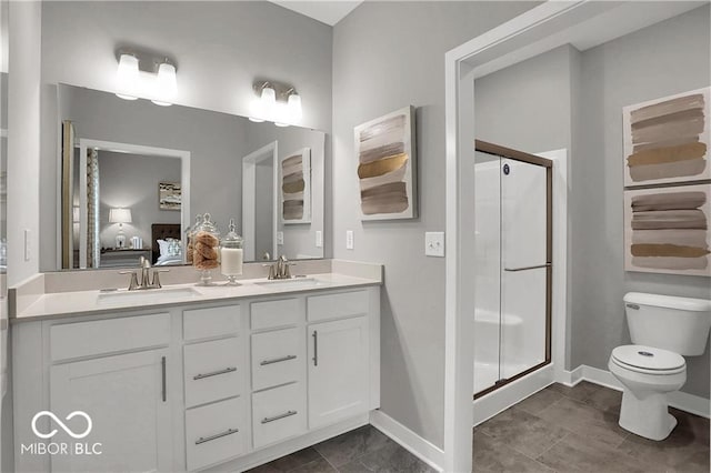 ensuite bathroom featuring a stall shower, a sink, toilet, and double vanity