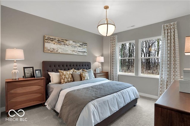 carpeted bedroom featuring visible vents and baseboards