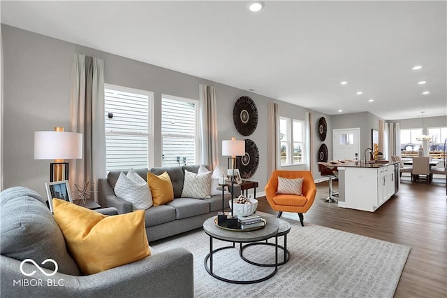 living room featuring dark wood-style floors, recessed lighting, and baseboards