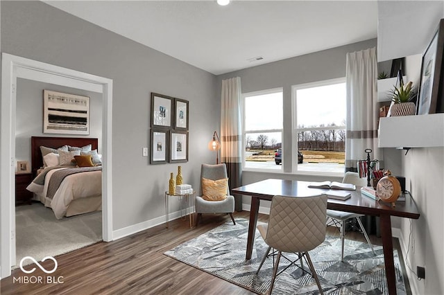 office area featuring visible vents, baseboards, and wood finished floors