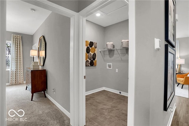 hallway featuring attic access and baseboards