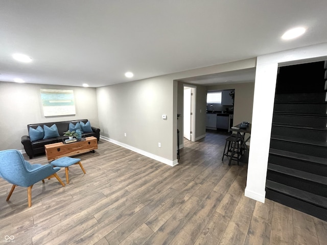 living room featuring hardwood / wood-style flooring and sink