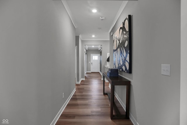 hall featuring baseboards, dark wood finished floors, crown molding, and recessed lighting