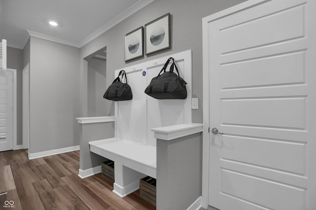 mudroom with dark wood-style floors, baseboards, ornamental molding, and recessed lighting