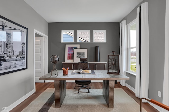 office space with wood finished floors and baseboards