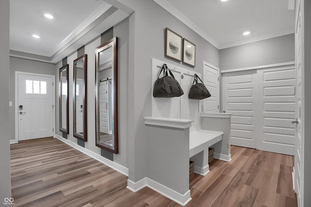 mudroom with ornamental molding, recessed lighting, wood finished floors, and baseboards