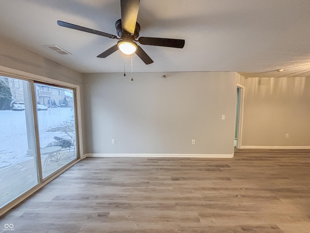 unfurnished room featuring light wood-type flooring and ceiling fan