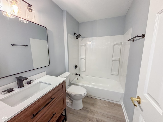 full bathroom with toilet, hardwood / wood-style flooring, shower / tub combination, and vanity