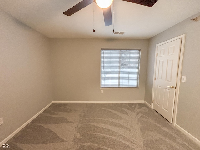 spare room featuring ceiling fan and carpet flooring