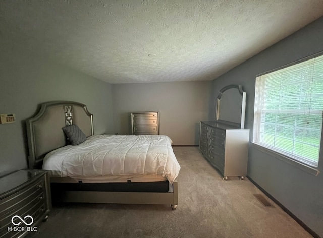 carpeted bedroom with a textured ceiling