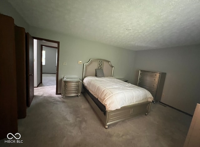 carpeted bedroom with a textured ceiling