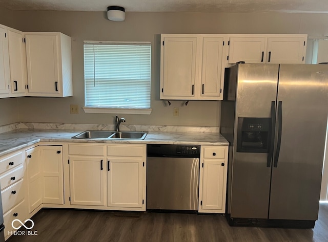 kitchen with white cabinets, sink, stainless steel appliances, and dark wood-type flooring