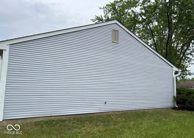 view of side of property with a yard