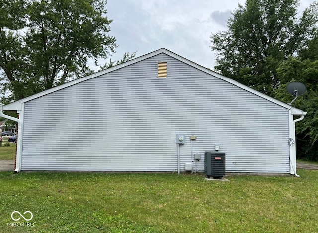 view of property exterior featuring a lawn and cooling unit