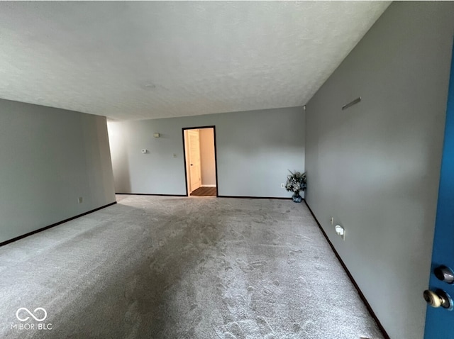 carpeted empty room with a textured ceiling