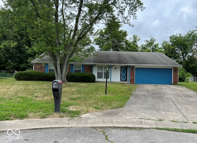 single story home with a garage and a front lawn