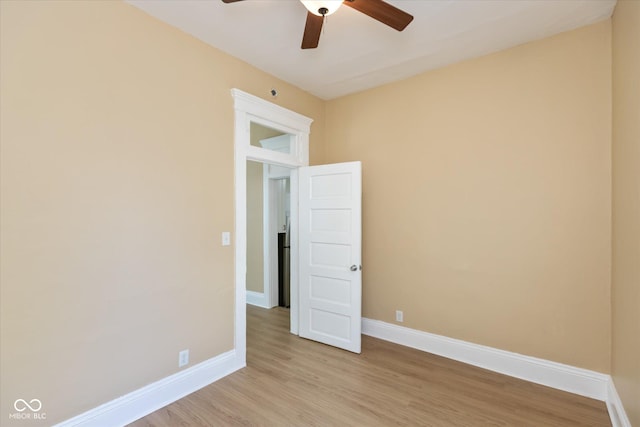 spare room with ceiling fan and light wood-type flooring