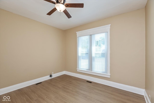 spare room with hardwood / wood-style flooring and ceiling fan