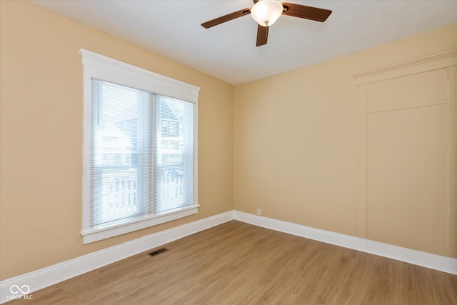 empty room with hardwood / wood-style flooring and ceiling fan