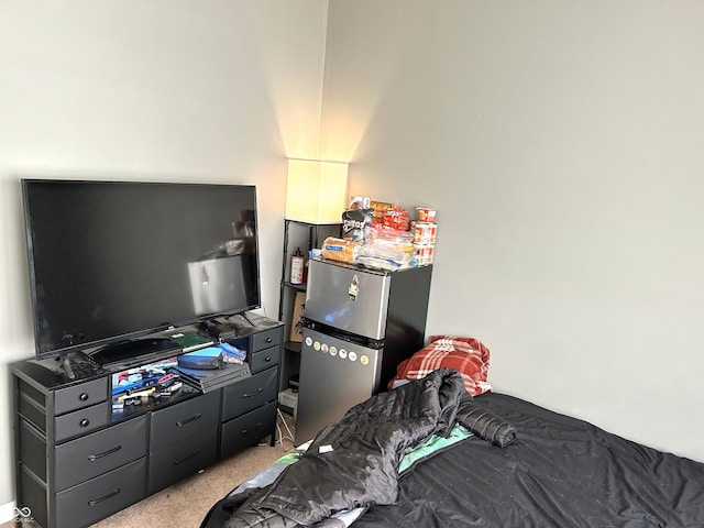 carpeted bedroom with stainless steel fridge