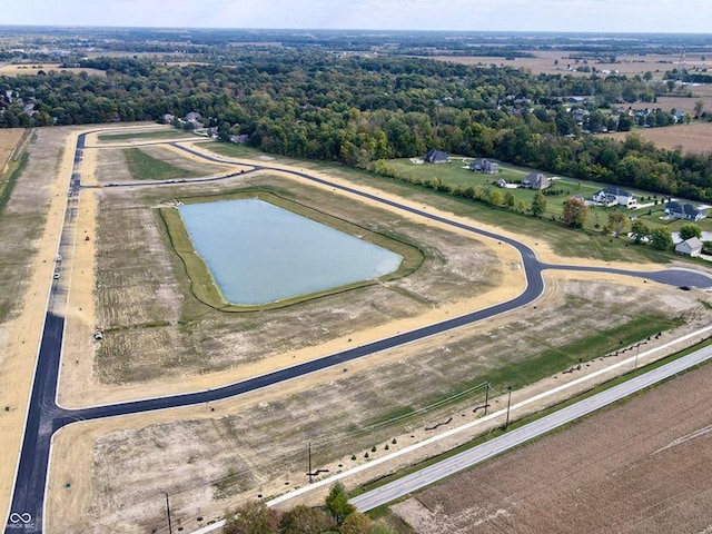 birds eye view of property featuring a water view and a rural view