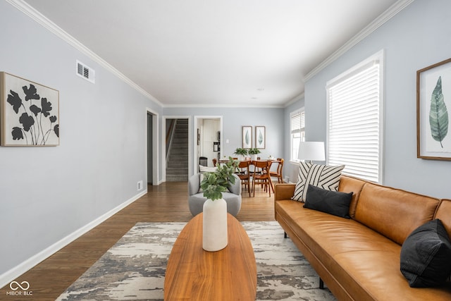 living room featuring hardwood / wood-style flooring and crown molding