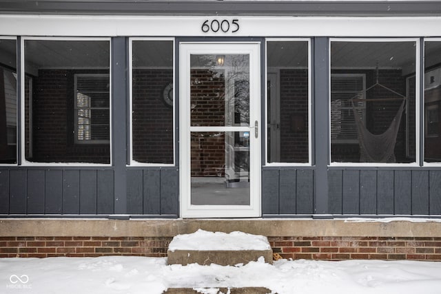 view of snow covered property entrance