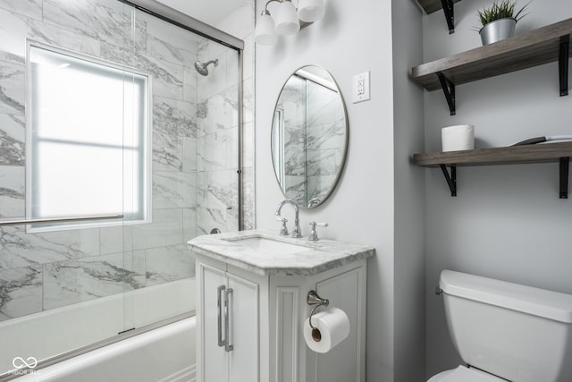 full bathroom with toilet, bath / shower combo with glass door, and vanity