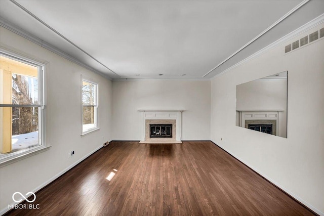 unfurnished living room with dark hardwood / wood-style flooring, a premium fireplace, and ornamental molding