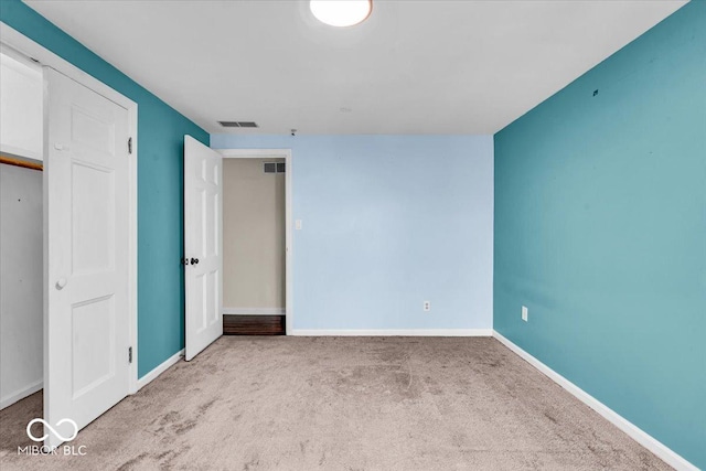 unfurnished bedroom with light colored carpet