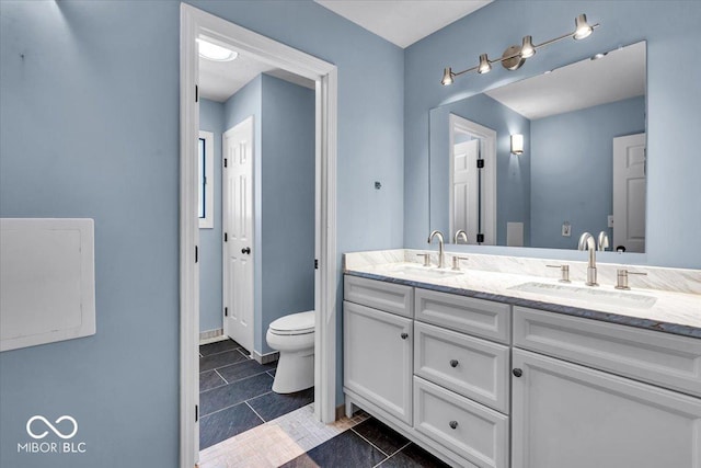 bathroom featuring toilet and vanity