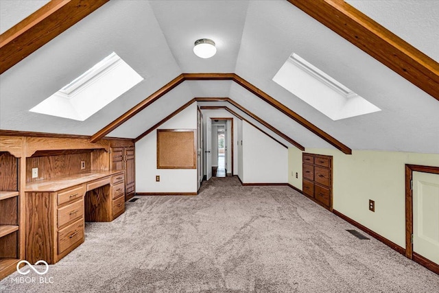 bonus room with lofted ceiling and light carpet