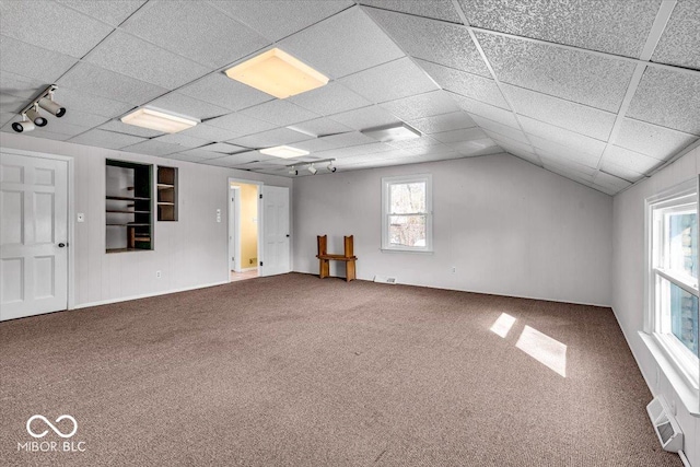 carpeted spare room with rail lighting