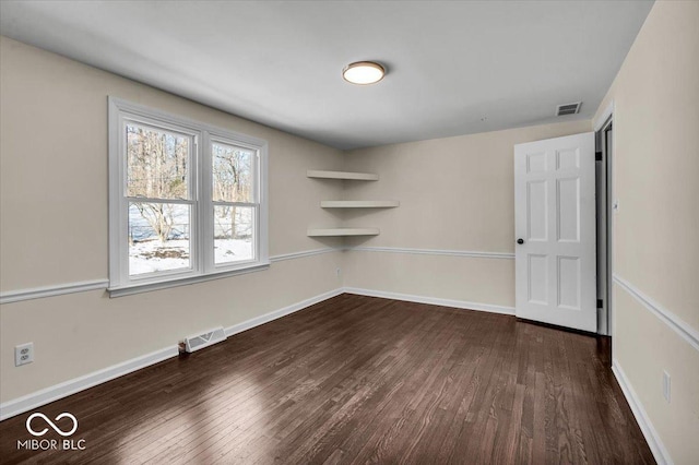 empty room featuring dark hardwood / wood-style flooring