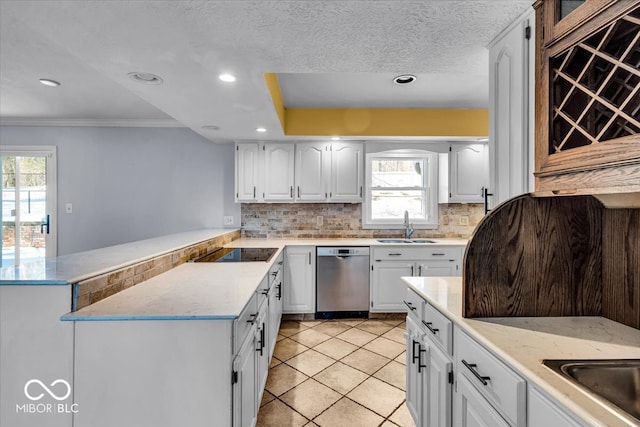 kitchen featuring white cabinets, stainless steel dishwasher, ornamental molding, and sink