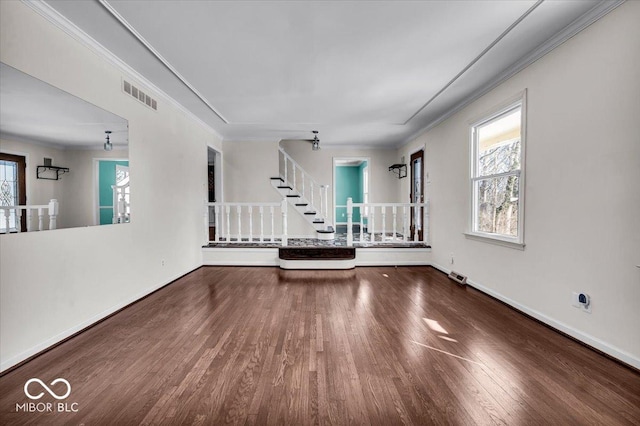 unfurnished living room with ornamental molding and hardwood / wood-style flooring