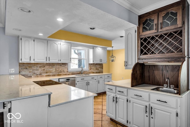 kitchen featuring sink, white cabinetry, stainless steel dishwasher, and kitchen peninsula