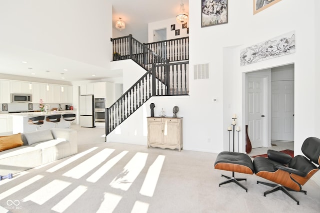 interior space featuring light carpet and a high ceiling