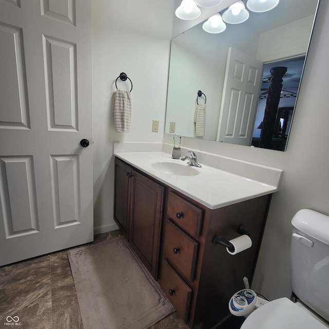 bathroom with vanity, ceiling fan, and toilet